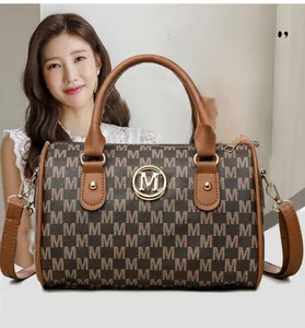 Close-up of vintage Boston bag featuring monogram print and golden metallic logo detail