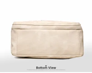 Macro bottom view showing textured beige canvas fabric and precise reinforced stitching