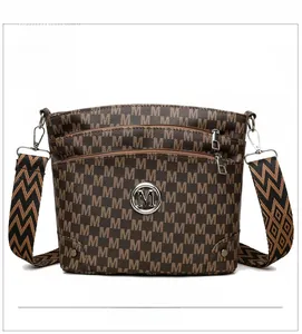 Detail of brown monogram shoulder bag with triple zip layers and wide woven strap