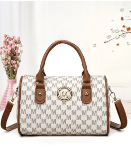 Detail showing the M-letter monogram pattern and gold metal logo on the Boston bag
