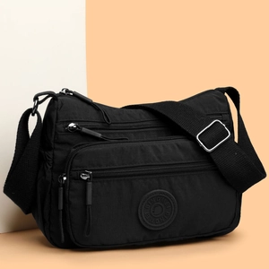 Waterproof black nylon crossbody bag with adjustable strap and multiple zipper pockets