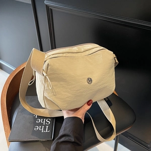 Lightweight beige crossbody dumpling bag with wide nylon strap for outdoor casual style