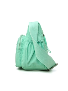 Detail view of mint green nylon crossbody bag showing side pocket and durable fabric texture