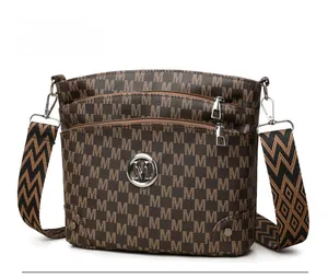 Detail of vintage brown monogram shoulder bag with multi-zipper and woven strap