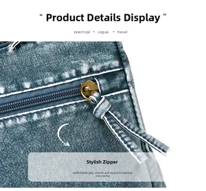 Detail of vintage washed blue bag showing the smooth bronze metal zipper and denim texture