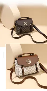 Detail view of jacquard pattern crossbody bag with golden metal logo and top handle