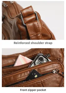 Detail of brown pebbled leather crossbody bag with reinforced straps and multi-layer zippers