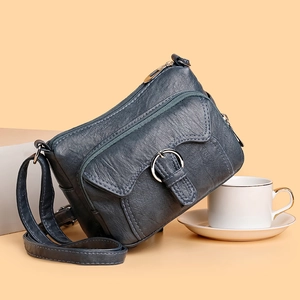 Gray-blue multi-pocket crossbody bag with pebble leather texture and adjustable strap
