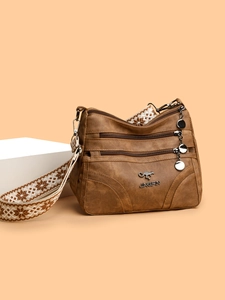 Brown textured faux leather tote bag with multi-layer zippers and ethnic style strap
