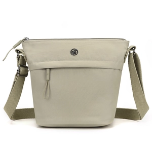 Minimalist sage green nylon crossbody bucket bag with wide strap and metal logo