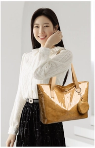 Brown tote bag with paper-like texture, white TOTE BAG print and round coin purse charm