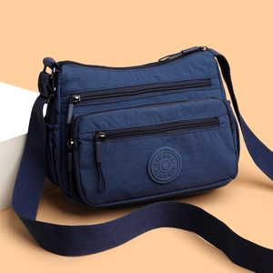 Waterproof dark blue nylon crossbody bag with multi-zipper compartments and wide strap