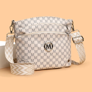 Women's cream crossbody bag with grey M-letter pattern and wide textured shoulder strap