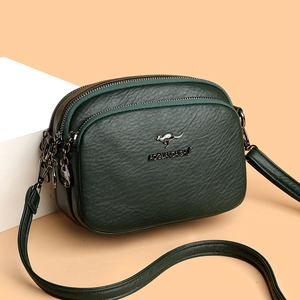 Deep green faux leather crossbody bag with three zipper layers and kangaroo metal logo