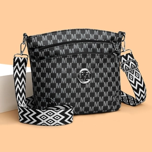 Vintage patterned crossbody bag with wide geometric strap and metallic logo