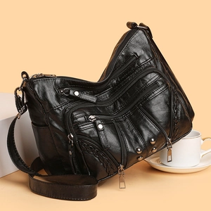 Black multi-pocket soft PU leather shoulder bag with silver studs and adjustable strap