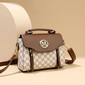 Vintage cream crossbody bag with grey monogram pattern and brown top handle design