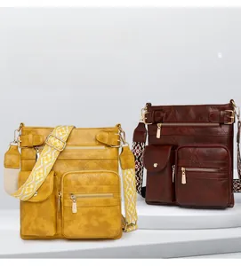 Close-up of retro PU leather shoulder bags in yellow and brown with ethnic style straps