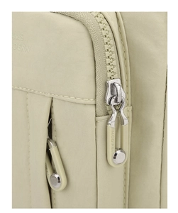 Detailed close-up of smooth zipper mechanism and durable canvas fabric on the shoulder bag