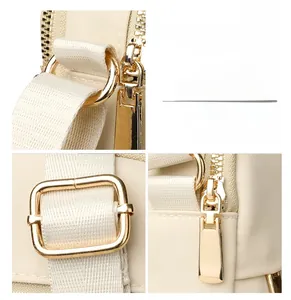 Close-up of polished gold hardware and beige nylon texture on a stylish crossbody bag