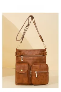 Close-up of brown PU leather crossbody bag with multiple pockets and metal zipper detail