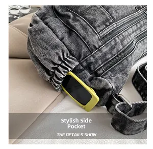 Gros plan de la poche latérale en denim noir avec cordon et lunettes de soleil jaunes