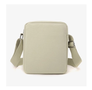 Close-up of beige canvas crossbody bag with adjustable wide strap and metal buckle