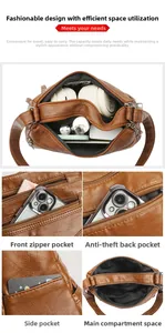 Detail view of brown soft leather crossbody bag with multiple zipper compartments and storage