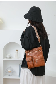 Brown vintage multi-pocket PU leather crossbody bag with stylish patterned wide strap