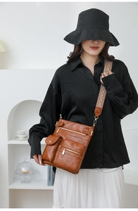 Close-up of vintage brown PU crossbody bag featuring ethnic embroidery wide strap