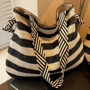 Striped straw beach tote bag with black and white woven texture and woven straps