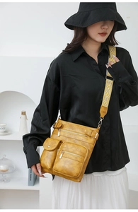 Detail of mustard yellow PU leather crossbody bag featuring a bohemian woven strap