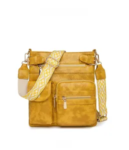 Front view of yellow PU leather crossbody bag featuring textured lychee grain and gold zippers