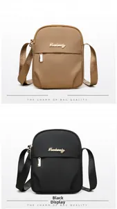 Detail view of khaki and black nylon mini crossbody bags with double zippers