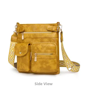 Side view of yellow PU leather crossbody bag with jacquard strap and gold hardware