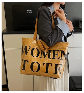 Side view of a large tote bag with WOMEN TOTE print on a model in an office setting