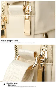Macro detail of the light gold zipper pull and D-ring on this beige nylon handbag