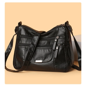 Detailed close-up of a black multi-pocket PU leather shoulder bag with silver zippers