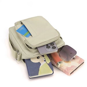 Minimalist beige canvas crossbody bag for men featuring multiple storage compartments