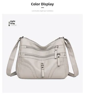 Detailed view of light grey soft PU leather crossbody bag with multiple front zipper pockets