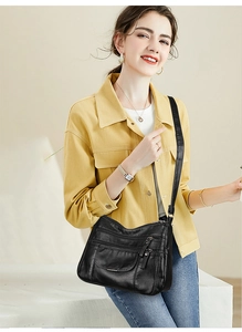 Detail of multi-layer soft leather crossbody bag with multiple zippers and flap pocket