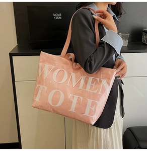 Close-up of pink fabric tote bag with transparent PVC overlay and white printed text