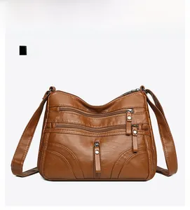 Detailed front view of brown soft PU leather crossbody bag with multiple zip pockets