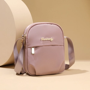Mini nylon phone crossbody bag in soft pink with triple zip layers and gold hardware