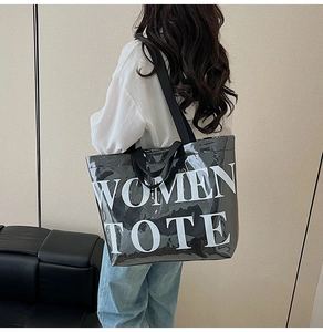 Detailed back view showing the large black glossy tote bag with white WOMEN TOTE text