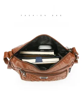 Detail view of large interior capacity of the brown quilted PU leather shoulder bag