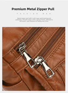 Close-up of premium silver dual metal zippers on a brown lychee pattern leather handbag
