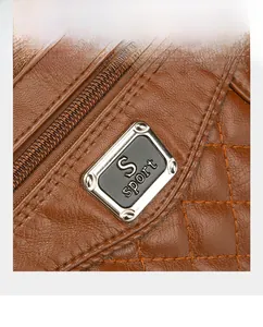 Close-up of quilted leather texture and metal zipper on a brown crossbody bag