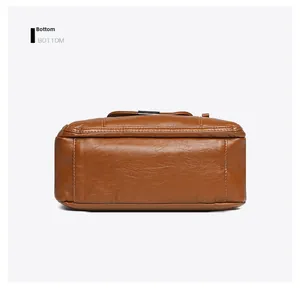 Detail shot of the reinforced bottom stitching and soft leather texture of the brown bag