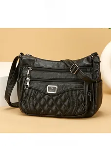 Macro shot of quilted pattern detail and smooth black synthetic leather on handbag